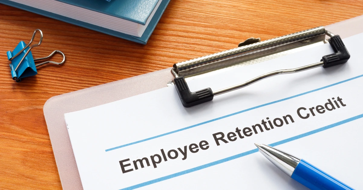 Employee Retention Credit document on a clipboard with a blue pen.