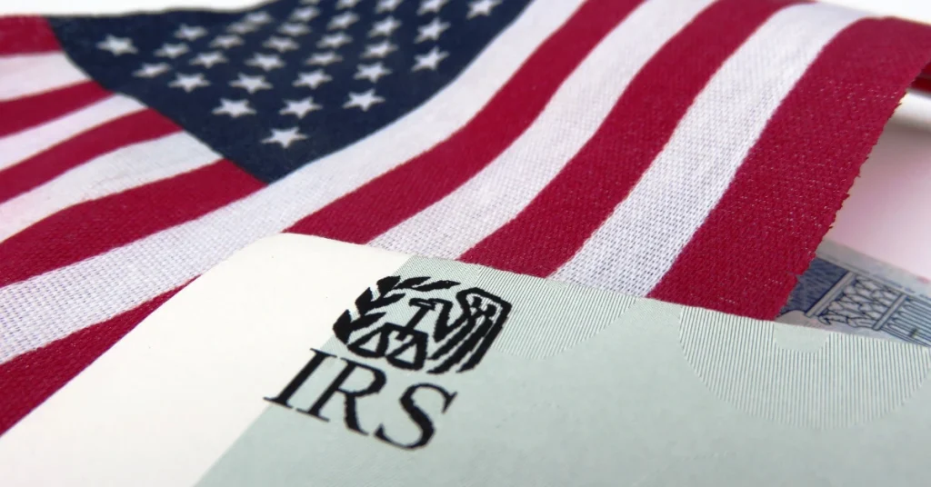 IRS logo on a document with the American flag in the background.