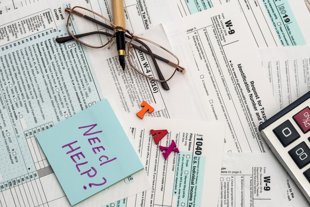 A cluttered desk with tax forms