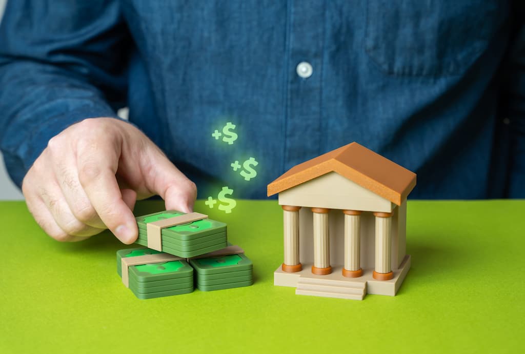 A person depositing money into a bank